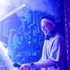 A shot of me at the DJ console, surrounded by atmospheric smoke and lights. I love creating a full sensory experience with both sound and visuals.
