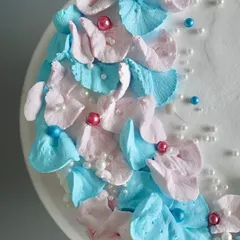 A close-up of the delicate floral work on my baby shower cake. The soft buttercream petals and pearl sprinkles make it a sweet and simple centerpiece for the celebration.