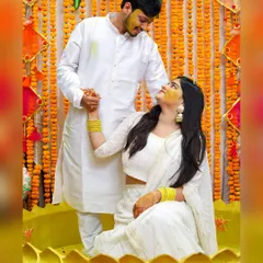 The Haldi ceremony is all about vibrant color and pure happiness. I captured this couple sharing a loving look amidst the celebration, coordinating in white outfits that made the yellow turmeric pop. It's a perfect example of candid wedding photography.