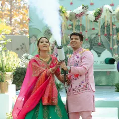 A fun and candid shot of the couple playing with a CO2 gun during their Haldi. It's important to capture the playful side of your relationship too.