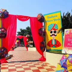 Welcome to the Rajasthani Mela. This quirky and colorful entrance sign and draped gateway immediately transport guests into a world of festive fun.