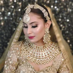 A regal golden lehenga paired with a heavy, intricate all-gold jewellery set, perfect for creating a luxurious and royal bridal look.