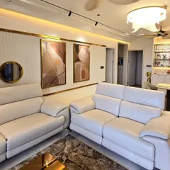 Here is an example of how custom art can complete a living room. This diptych, featuring flowing abstract forms in an earthy palette, was designed to complement the room's elegant decor and warm lighting.