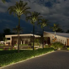 The approach to the farmhouse at dusk, with landscape lighting highlighting the palm trees and modern architectural forms. The design creates a resort-like feel, promising a luxurious escape from the everyday.