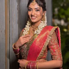 A beautiful portrait of a South Indian bride, her makeup enhancing her natural features and complementing her traditional attire.