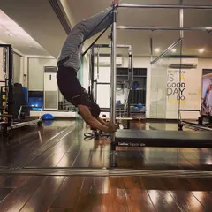 A branch that does not bend, breaks. This inverted pose on the Cadillac demonstrates extreme flexibility and control. My training focuses on building this kind of resilient strength, improving your mobility and preventing injuries.