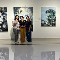 We love it when our guests feel at home. Here, visitors pose with some of the portraits from the "Legends of Our Time" exhibition, becoming part of the gallery's story for the evening.