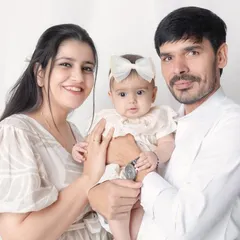 A classic portrait of a new family. Holding your baby together for one of your first family photos is a moment you'll never forget.