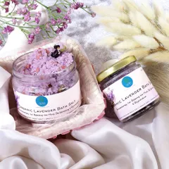 A delicate and soothing image of organic lavender bath salts. The soft fabrics, gentle lighting, and hints of purple flowers create a serene, spa like atmosphere, emphasizing the product's relaxing properties.