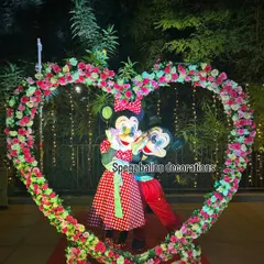 A picture-perfect moment with Mickey and Minnie Mouse inside a custom floral heart arch. I can help arrange these special photo opportunities to capture beautiful memories from your celebration or event.