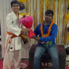 Another young orange belt student participating in our Teacher's Day celebration, part of our academy's family culture.