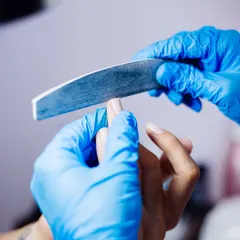 The foundation of a perfect manicure. Our technician carefully files the nail to create a smooth and uniform shape, ensuring a flawless result.