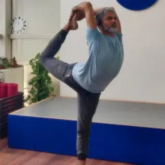 My background as a dancer deeply influences my practice. Here in Natarajasana, or Lord of the Dance Pose, I find a connection between rhythmic movement and steady balance. This asana builds focus, opens the shoulders, and strengthens the legs.