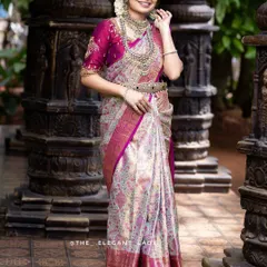A gorgeous cream and magenta silk saree, perfect for a bride who wants a blend of subtle and vibrant tones. The silver zari work gives it a contemporary feel while remaining deeply traditional.