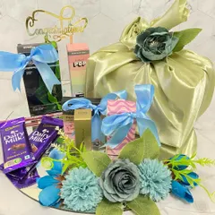Reflecting love in every detail. This congratulations hamper on a mirror base is adorned with blue and green flowers and filled with chocolates and other treats to celebrate an achievement.