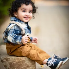 A bright, happy smile from this dapper little man. The soft, blurred background keeps all the focus on his joyful expression.