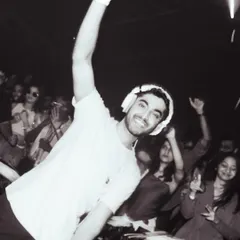 A black and white shot of me connecting with the crowd during a set. A smile and a hand in the air, it’s all about sharing the good vibes.