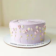 A lovely lavender cake with tiny, intricate buttercream flowers piped around the side. This design showcases my detailed piping work and is perfect for a sophisticated celebration.
