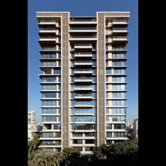 The completed facade of our residential project on Pali Hill, Mumbai. The design uses clean vertical lines and expansive glass panels to create a modern and sophisticated aesthetic that complements its upscale urban surroundings.