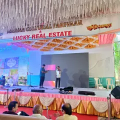 This is a practical stage setup for a public or community event. It includes a branded backdrop for sponsors, a large LED screen for visuals, and basic stage skirting, ensuring a functional and professional look.