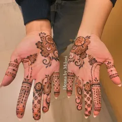A minimal design for an engagement, with a simple floral motif on the palm and detailed fingers.