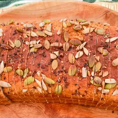 A close look at my signature flourless lentil bread. It's topped with a healthy mix of pumpkin, sunflower, chia, and sesame seeds for extra nutrition and crunch. This is a gluten-free bread you can enjoy without worry.