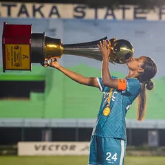 The sweet taste of victory. Our captain kisses the hard-earned Karnataka Women's League trophy, a moment that captures years of dedication and sacrifice.