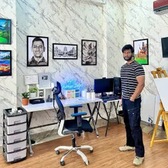 My personal workspace within the studio, where I create my own pieces. The walls are decorated with my art, from portraits to landscapes, to serve as inspiration.