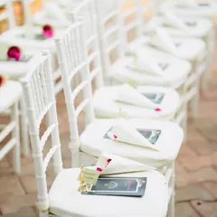 The guest seating for an elegant outdoor ceremony. I arranged classic white Chiavari chairs, each with a personalized stationery set and petal cone, ensuring every guest felt welcomed and included in the celebration.