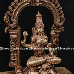 A beautiful bronze Mahalakshmi statue, framed by an ornate Prabhavali (arch). This is a perfect idol for Akshaya Tritiya, a day that celebrates endless prosperity.