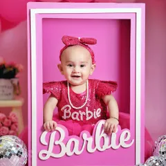 A real-life Barbie doll. This little girl looks absolutely perfect in our custom Barbie box prop, part of a fun and vibrant pink-themed sitter session.