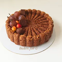 My whole wheat Bundt cake decorated with fresh cherries, grapes, and assorted chocolates. The intricate shape of the cake itself is a beautiful centerpiece.