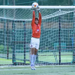 Safe hands. Our goalkeeper confidently claims the ball during a crucial moment in a Mumbai Football Association match, showcasing the reliability and skill of our last line of defense.