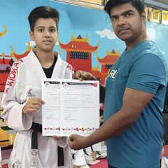 Another gold medalist from the SGFI District Karate Championship, proudly holding his certificate before heading to the state competition.