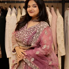 This is another shot of the intricately embroidered mauve-pink lehenga, showing how it looks from the front. The sheer dupatta adds a layer of grace to the overall outfit.