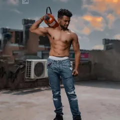 Taking the shoot to a Gurgaon rooftop at sunset. This on-location fitness photo combines a gritty, urban environment with a well-defined physique, showing how we can create epic visuals outside the studio.