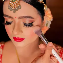 A close up of the finished Rajwara bridal look. Notice the soft blush application, the perfectly blended eyeshadow, and the crisp red lip that brings the entire look together.