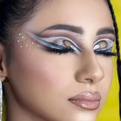 A close-up of the illusionistic eye makeup. This look plays with negative space and contrasting colors to create a captivating effect, a technique we teach in our advanced editorial makeup modules.