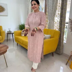 Another shot of my Teej outfit, showing the simple elegance of the custom-stitched pink kurta against my home's decor.
