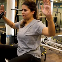 Every session is customized for your body. This client is focusing on her form during an upper body exercise, building strength at her own pace with my guidance.
