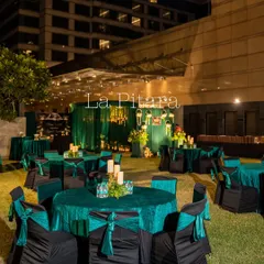 An overview of the outdoor seating arrangement at the Crowne Plaza. We used emerald green linens and black chair covers with matching sashes to create a rich, elegant look for this corporate Diwali celebration.