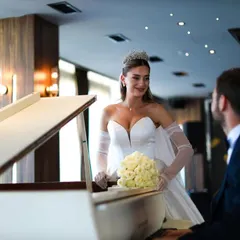 A sweet, candid moment between the bride and groom at a piano. This image captures the romance and elegance of their Dubai wedding celebration.