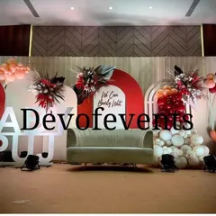 A modern and stylish baby shower stage with a "We Can Bearly Wait" theme. I used a bold color palette of red and peach, with large marquee letters, arched backdrops, and floral accents.