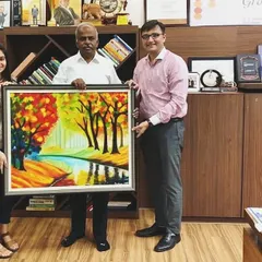 Dr. Arokiaswamy Velumani with the custom autumn landscape I created for him. This piece was made entirely with a palette knife to achieve its rich, warm colors and textures.