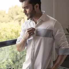A full view of the color-block shirt, showing the contrasting cuff detail. It’s a quiet masterpiece, woven for warm days and cool moments.