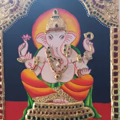 A close-up of a Tanjore painting of Lord Ganesha, created by my student Indu. Note the detailed gold foil work and stone embellishments that are characteristic of this style.