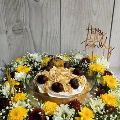 Make their birthday truly special with a complete celebration in a box. This floral hamper features my moist Cherry Almond Tres Leches cake, surrounded by a bed of fresh, vibrant flowers and topped with a custom birthday message.