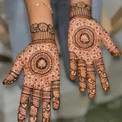 A beautiful, full-hand design for a bridesmaid, featuring a central lotus mandala surrounded by intricate floral patterns.