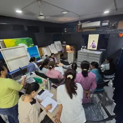 Our instructor leads a class, using a screen to display reference images while students follow along. This blend of traditional and modern teaching helps everyone learn effectively.