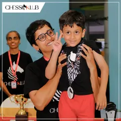 It's all about encouragement and fun. One of our youngest winners celebrating his achievement with a team member, reflecting the supportive family atmosphere we nurture at the Klub.